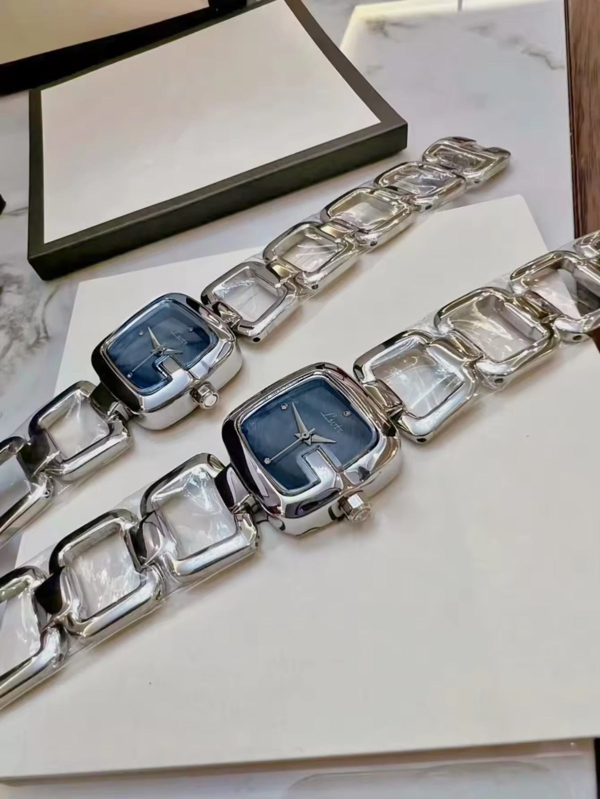 Women’s silver cushion square watch with black mother of pearl dial and open
square-link bracelet — Le Belle Heure